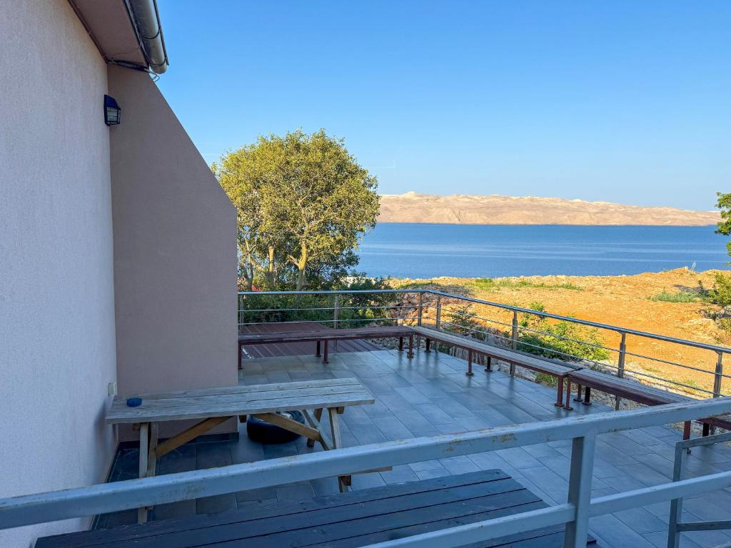 a balcony with benches and a view of the water at Lantana ex Villa Americana in Karlobag
