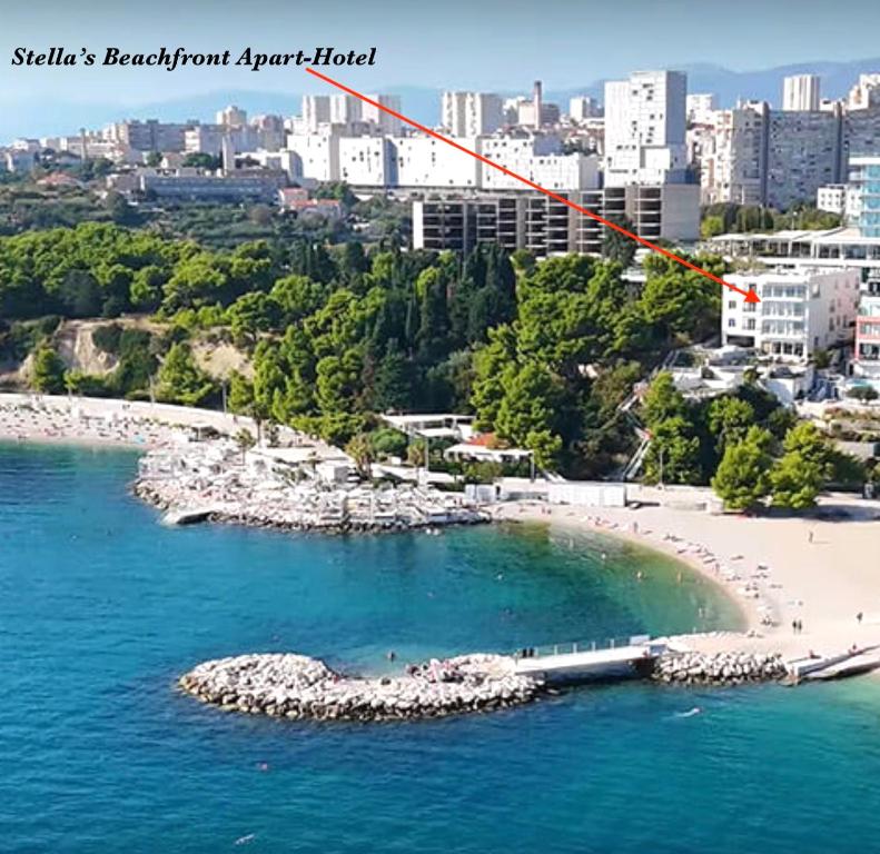a small island in the water next to a city at STELLA'S BEACHFRONT Aparthotel in Split