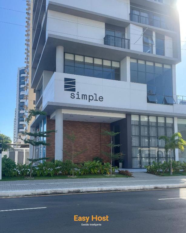 a large apartment building with a large sign on it at Simple Smart Residence - By EasyHost in Tambaú