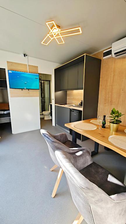 a kitchen with a table and chairs in a room at Relax Tiny House Ljubljana in Ljubljana