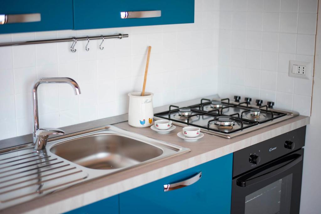 a kitchen with a sink and a stove at Villa Sofia in Taormina