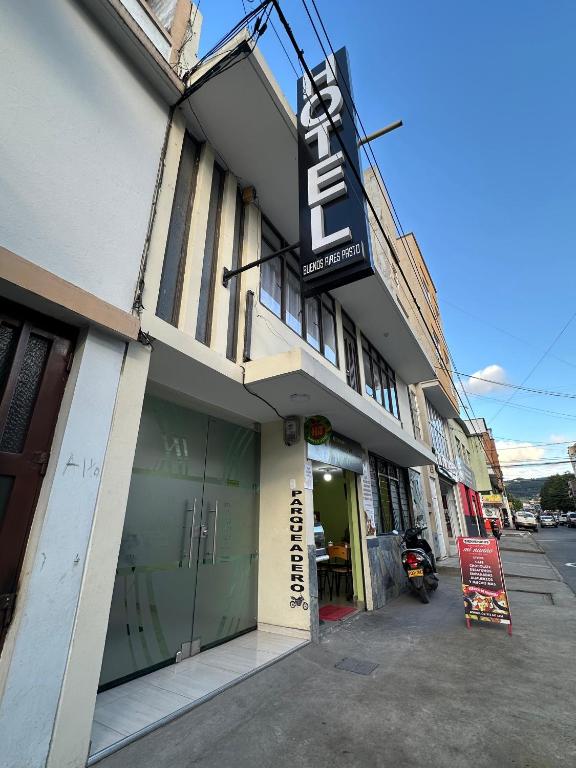a store with a sign on the side of a building at Hotel Buenos Aires in Pasto