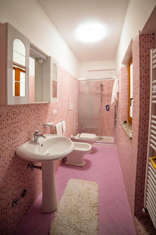 a bathroom with two toilets and a sink and a shower at Villa Sofia in Taormina