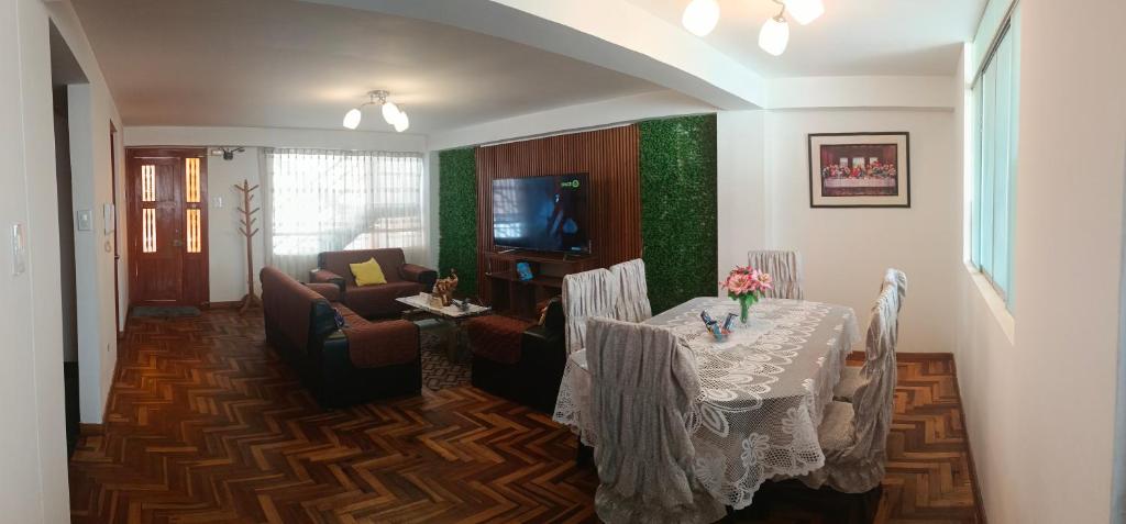 a living room with a table and a couch at WaskarWasi in Cusco