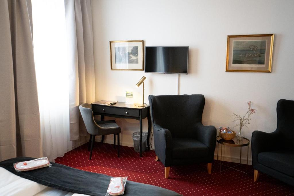 TV a/nebo společenská místnost v ubytování Hotel Vinhuset