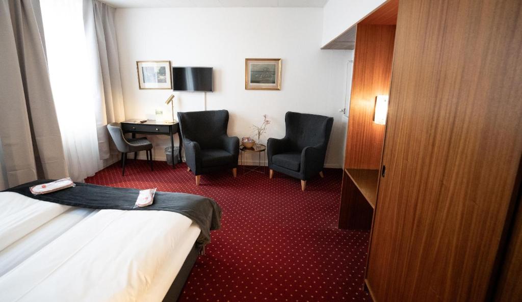Postel nebo postele na pokoji v ubytování Hotel Vinhuset