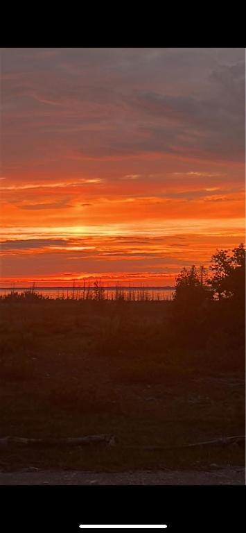 a sunset in a field with the sky at Tobermory Tides bed and breakfast in Tobermory