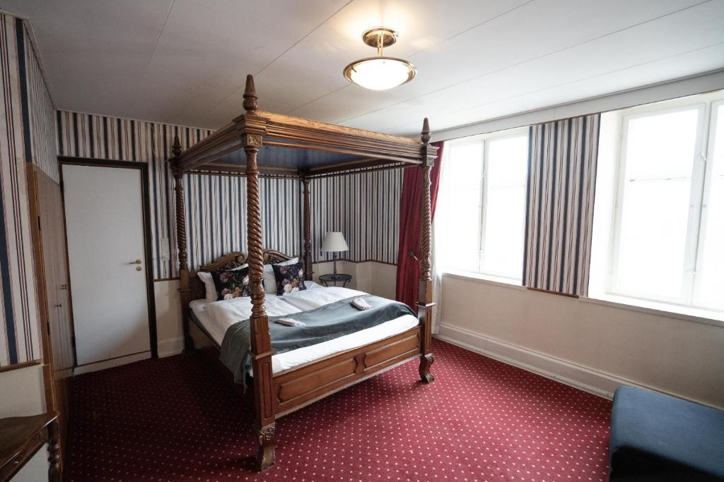 Postel nebo postele na pokoji v ubytování Hotel Vinhuset