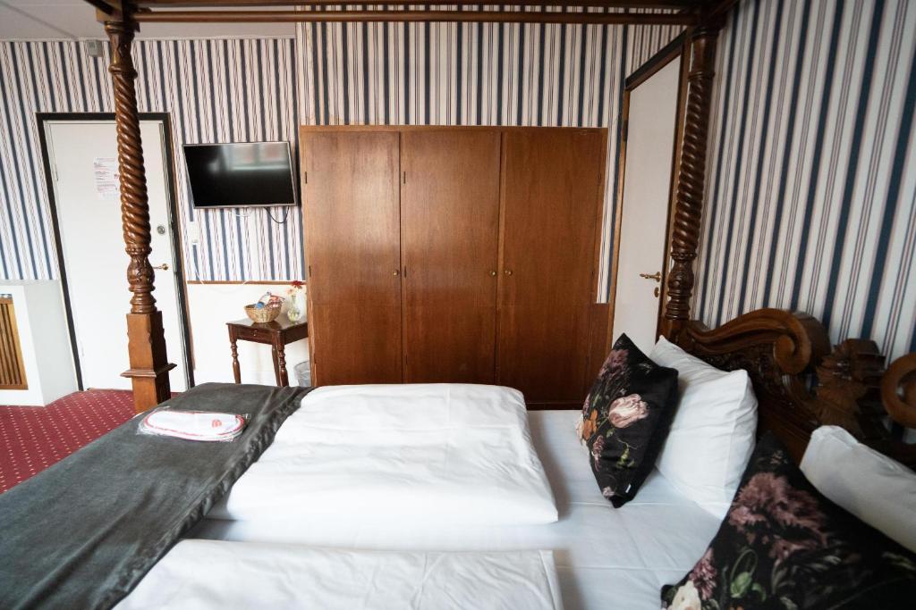 Postel nebo postele na pokoji v ubytování Hotel Vinhuset