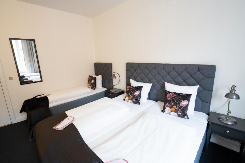 Postel nebo postele na pokoji v ubytování Hotel Vinhuset