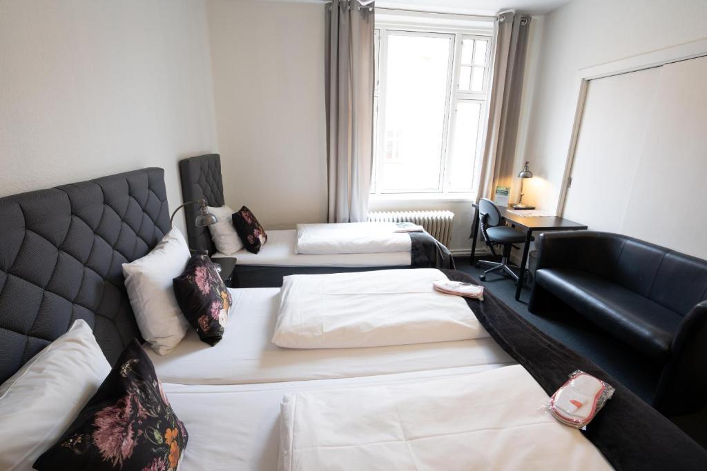 Postel nebo postele na pokoji v ubytování Hotel Vinhuset