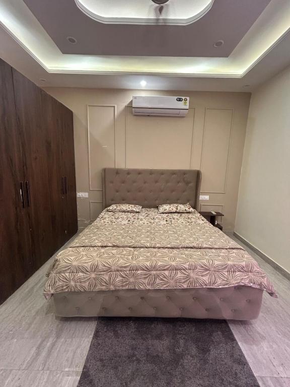 a bedroom with a bed in a room at Beauty Living in Kharar