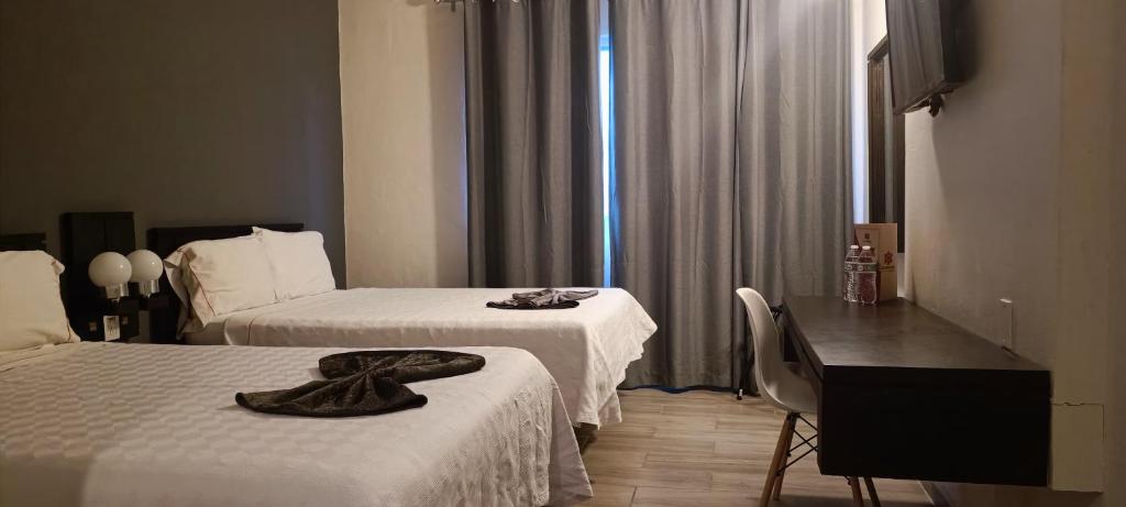 Postel nebo postele na pokoji v ubytování Hotel Las Pergolas
