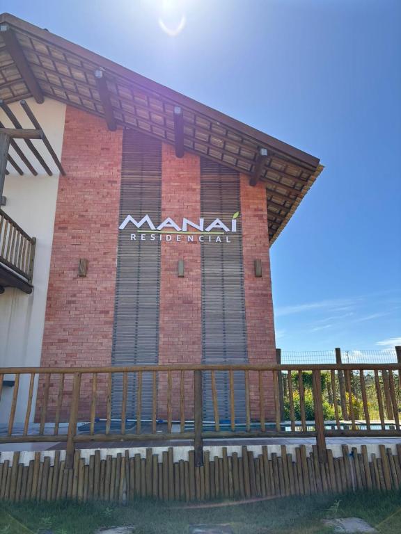 a building with a sign on the side of it at Barra Grande Flat Manaí in Marau