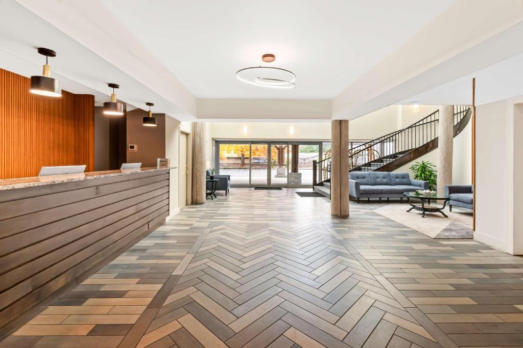 an office lobby with a reception counter and a staircase at Hotel Feng, BW Signature Collection in Parksville
