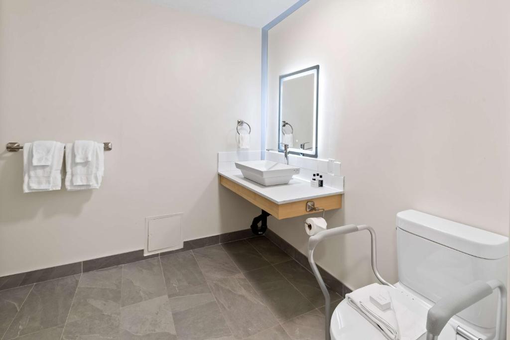 a white bathroom with a sink and a toilet at Hotel Feng, BW Signature Collection in Parksville
