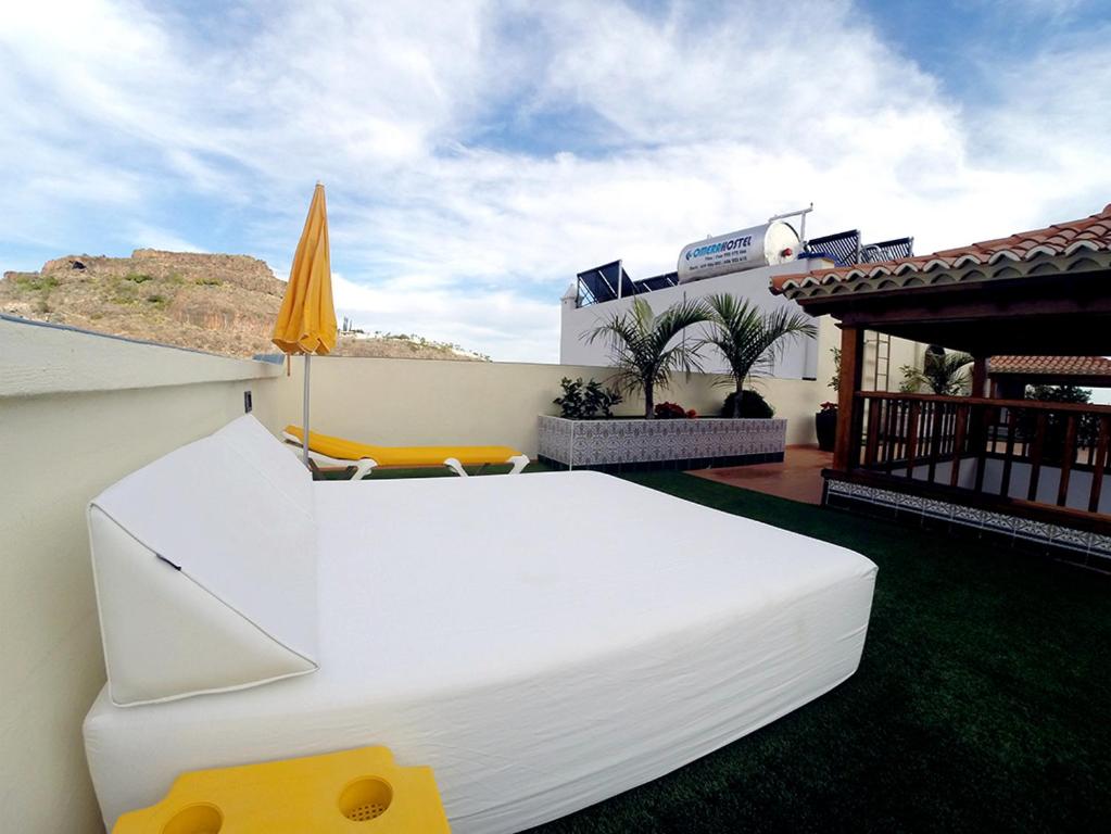 a white bed sitting on top of a patio at Apartamentos Tapahuga in Playa de Santiago