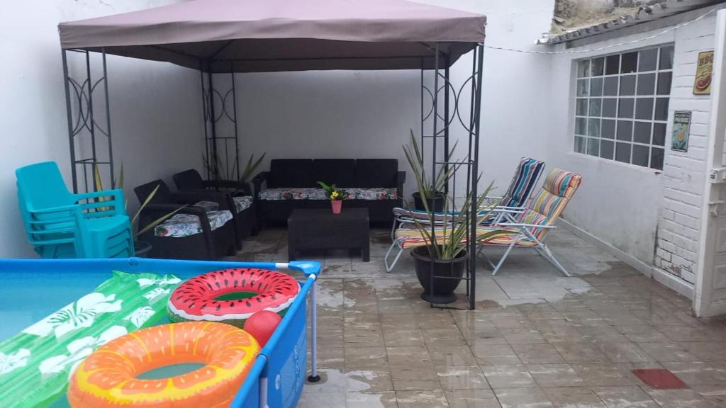a patio with a tent with chairs and a table at Casa Villetana in Villeta