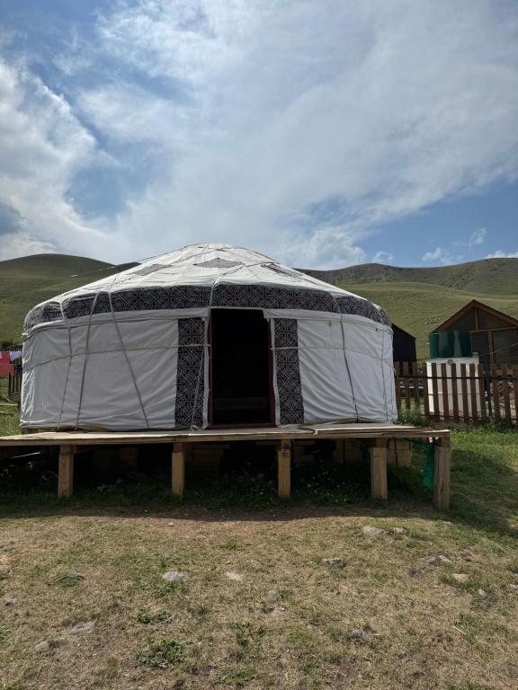 a tent sitting on a table in a field at Юрты РАЯНА in Kurmenty