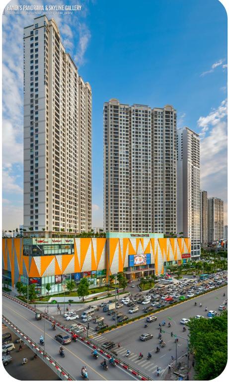 a city with tall buildings and a parking lot with cars at Tami Homes - Vinhomes D'Capitale Executive Apartment in Hanoi