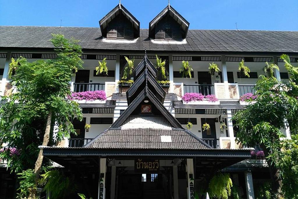 a building with a building with a roof at Baan Orawee Boutique Hotel in Mae Rim