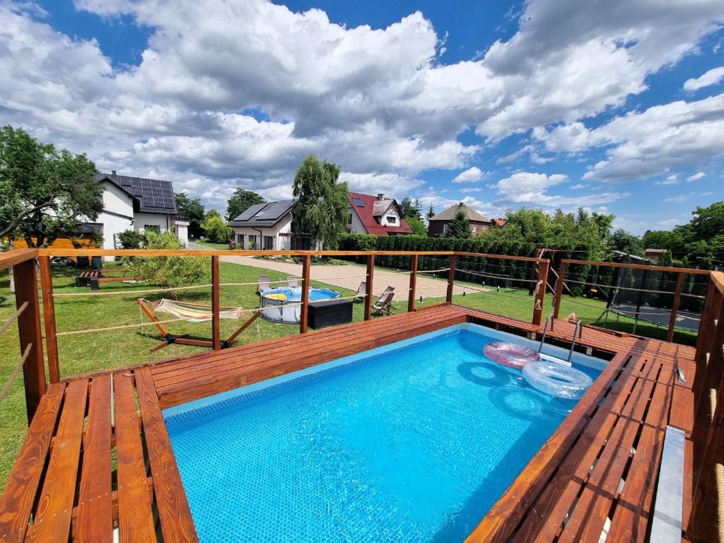 a swimming pool on a deck with a deck at Lawendowy Domek Boutique Resort, Zator, Przeciszów in Zator