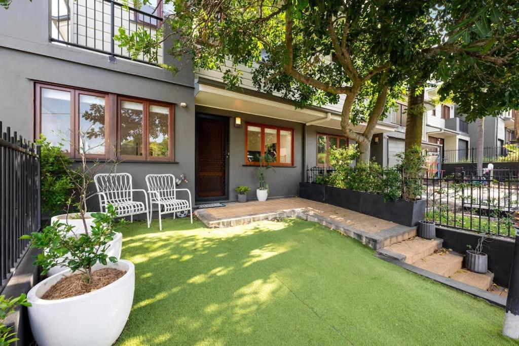 a house with a small yard with a lawn at Inner City Townhouse in Brisbane