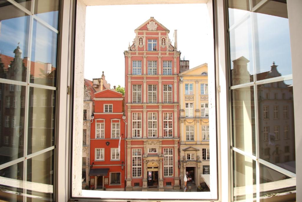 a view of a large building from a window at Długa Apartments Old Town in Gdańsk