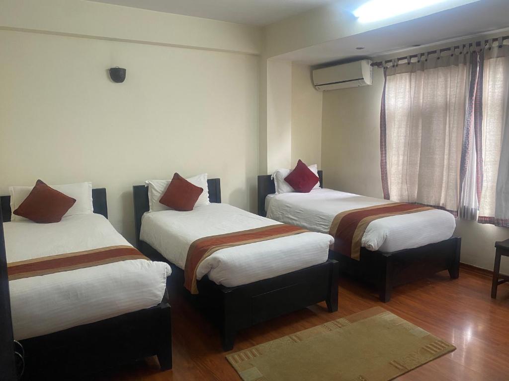 Postel nebo postele na pokoji v ubytování Thamel Eco Resort