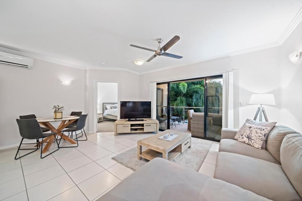 a living room with a couch and a table at Beachside 2 bed 2 bath unit in Townsville