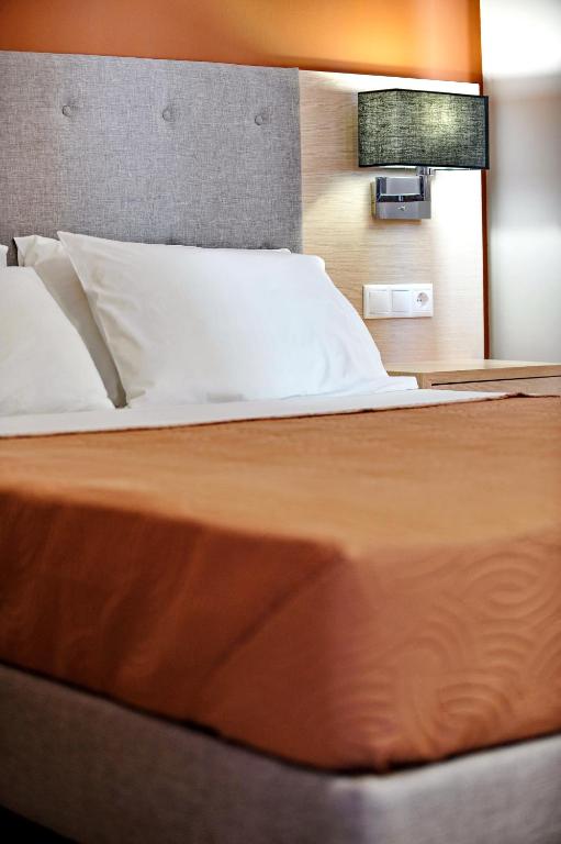 Postel nebo postele na pokoji v ubytování Vliho Bay Boutique Hotel