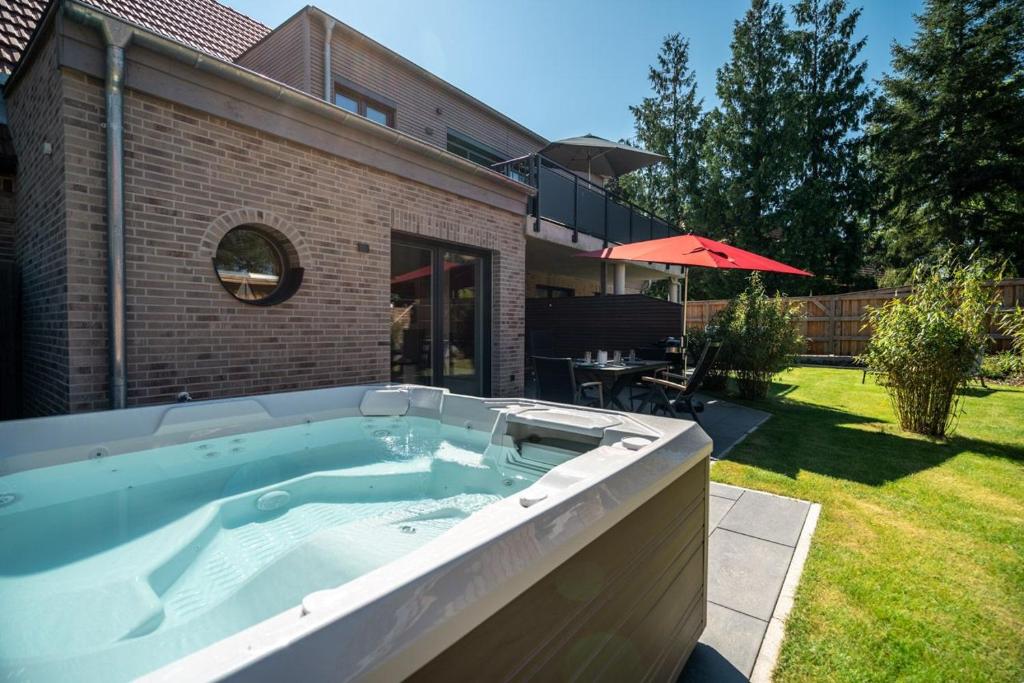 a large swimming pool in a yard with a house at Ferienwohnung FleesenNest in Göhren-Lebbin