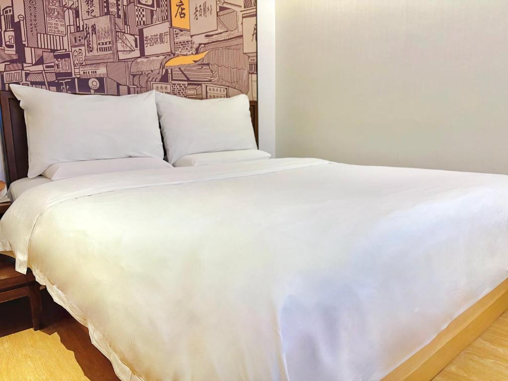 Postel nebo postele na pokoji v ubytování Guangzhou City Join Hotel Shipai Qiao metro Branch
