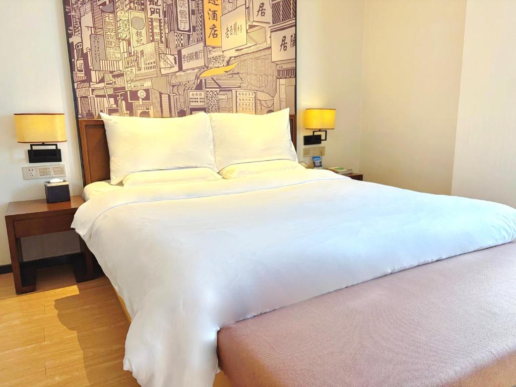 Postel nebo postele na pokoji v ubytování Guangzhou City Join Hotel Shipai Qiao metro Branch