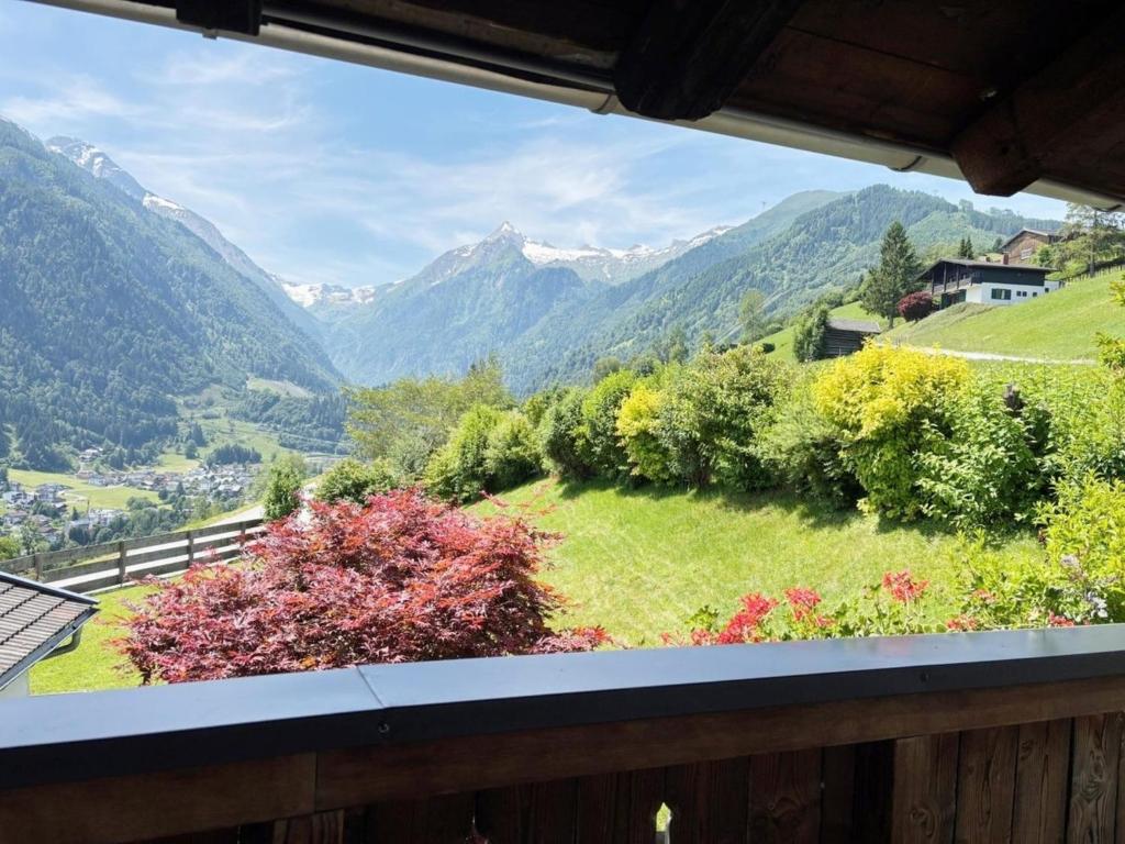 a view from the balcony of a house with mountains at Apartment Maiskogel - directly on the ski slope in Kaprun
