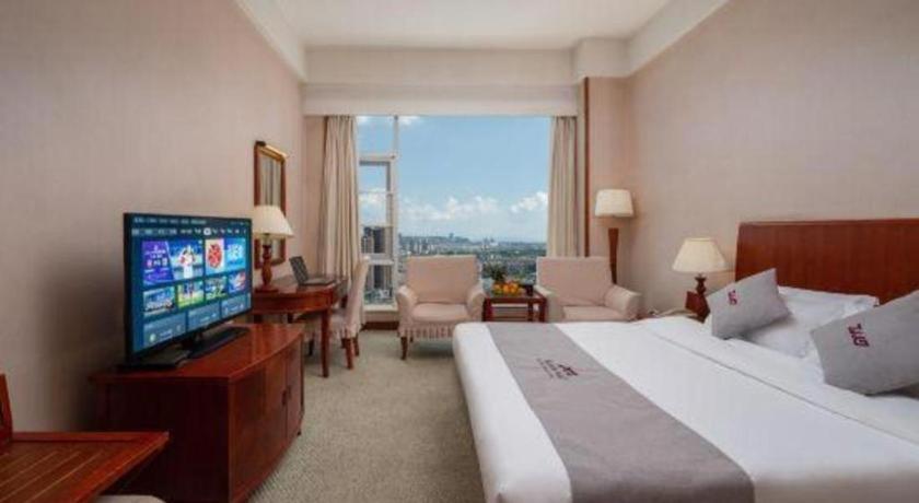 Postel nebo postele na pokoji v ubytování Kunming Plateau Pearl Hotel