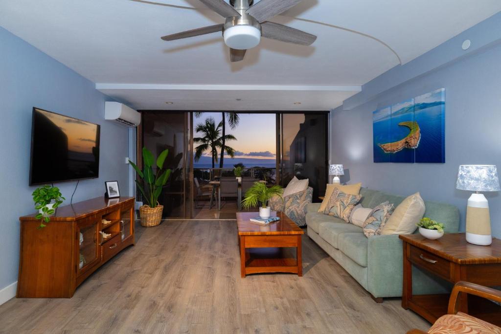 a living room with a couch and a tv at Oceanview Kahana Villa - Walk to Beach & Dining in Kahana