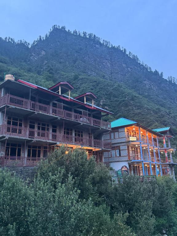 a large building with a mountain in the background at Cafekush tosh in Tosh