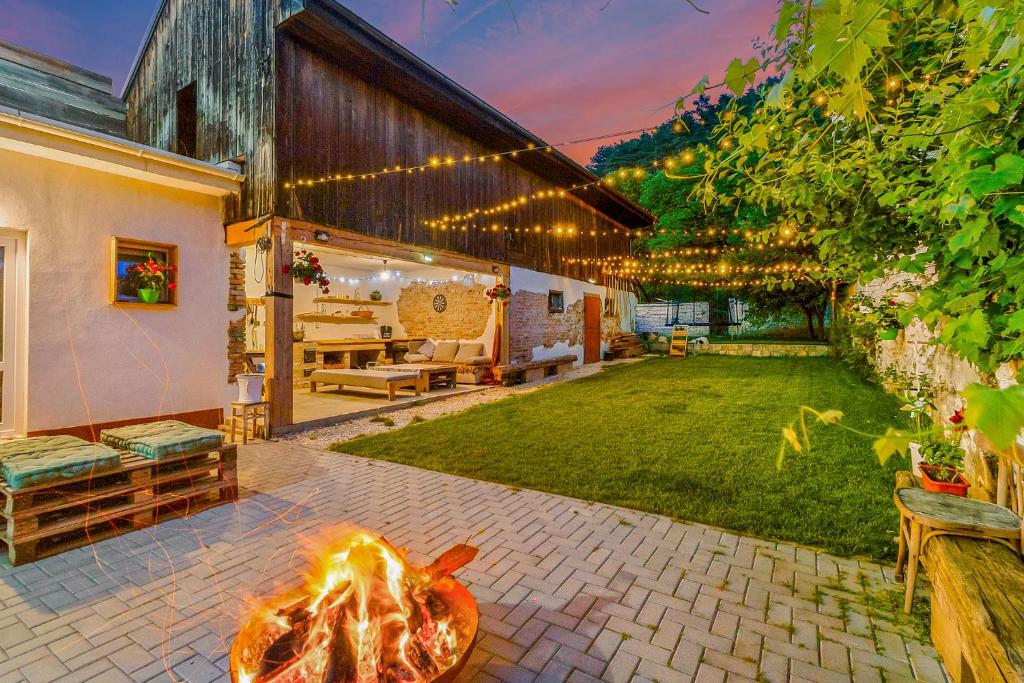 an outdoor patio with a fire pit in the yard at IMPERFECT house in Râşnov