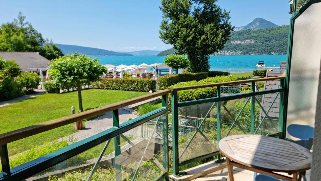 d'un balcon avec une chaise et une vue sur l'eau. dans l'établissement Studio les pieds dans l'eau, à Duingt