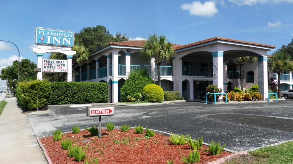 a sign in front of a inn at Flamingo Inn in Kissimmee