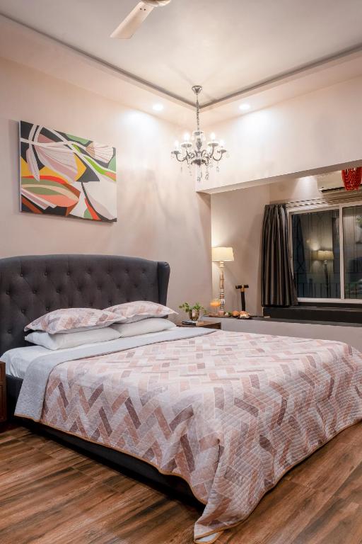 a bedroom with a bed and a chandelier at BOHO Bari in Kolkata