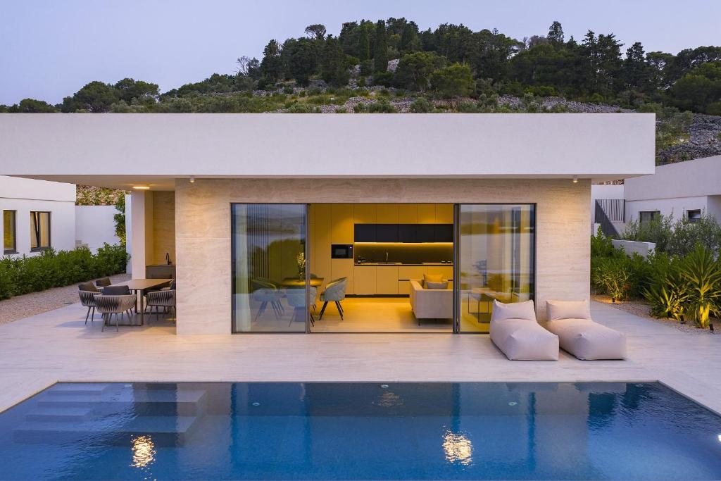 a house with a swimming pool in front of it at Cloud 9 D6 in Tkon