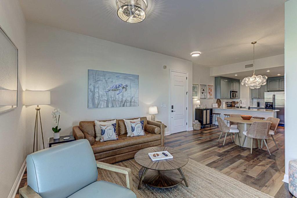 a living room with a couch and a table at Waterfront Condo for 4 with Resort Pool & Lake View in Horseshoe Bay