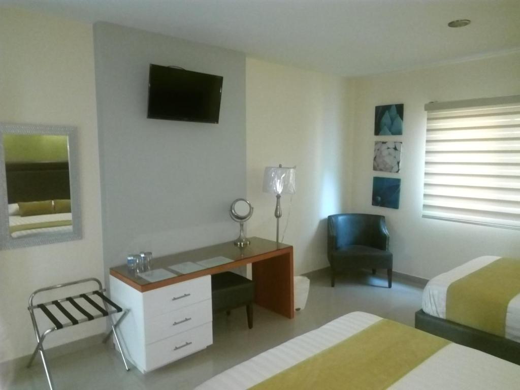 TV a/nebo společenská místnost v ubytování Hotel Tierra Roja