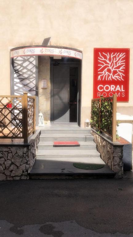 a front entrance to a hotel with stairs and a sign at Coral Rooms in Torre del Greco