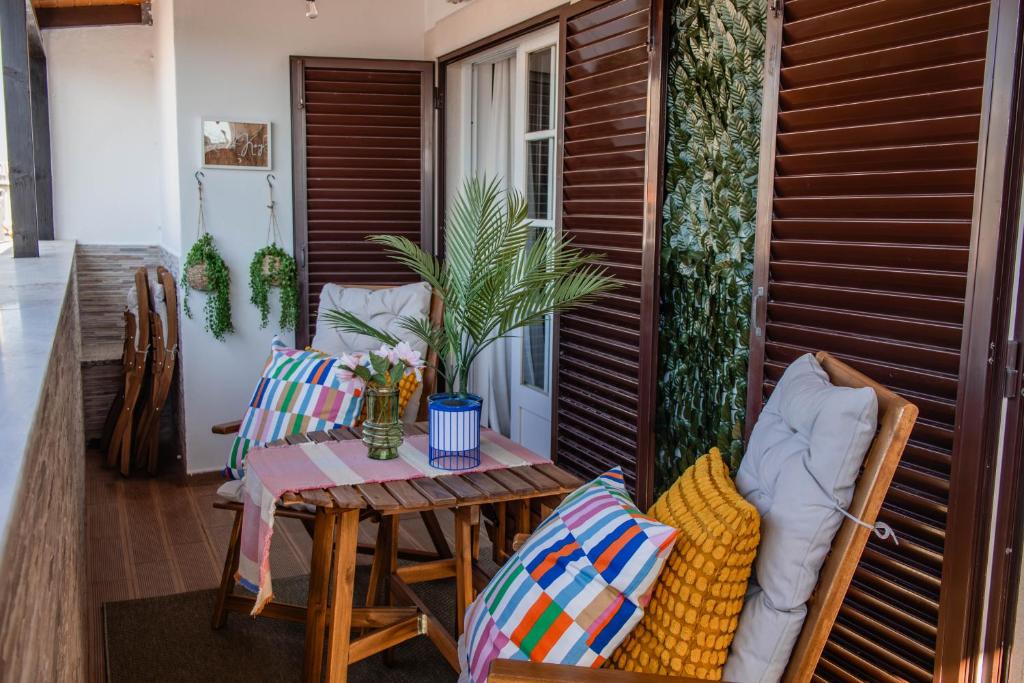 a patio with a table and chairs on a balcony at House Pachamama in Olhão