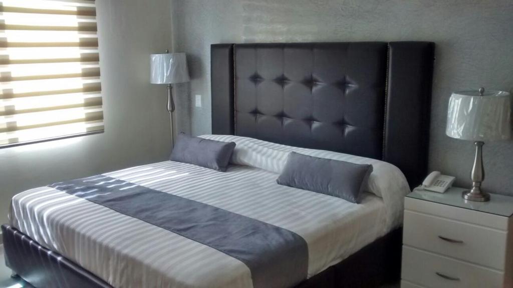 Postel nebo postele na pokoji v ubytování Hotel Tierra Roja