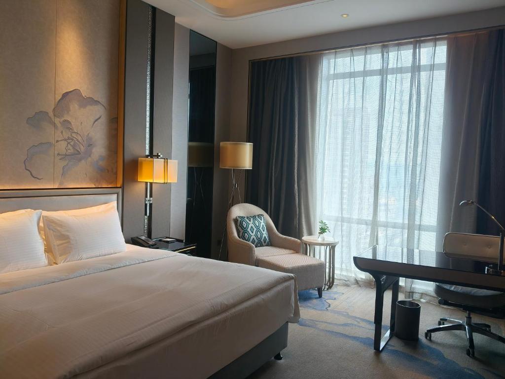 Postel nebo postele na pokoji v ubytování Wanda Realm Liuzhou
