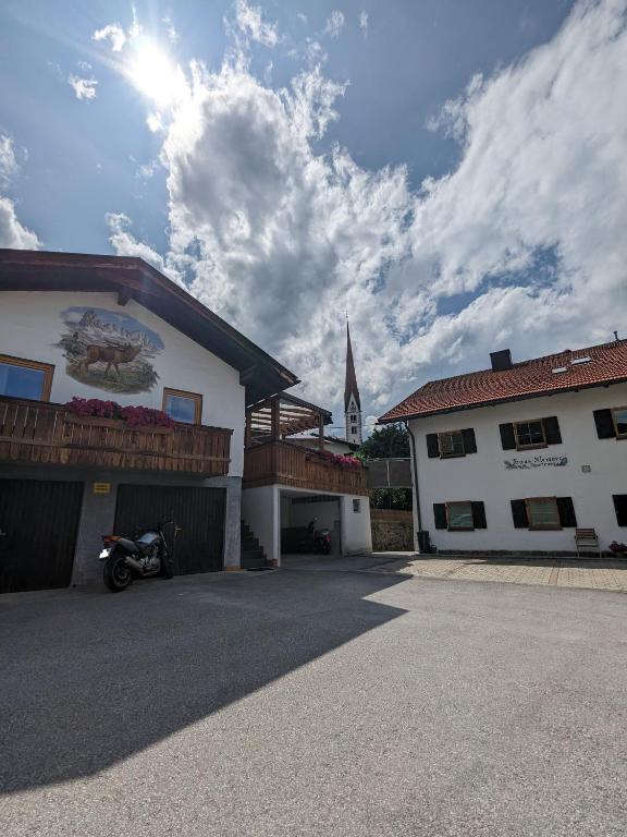a building with a motorcycle parked next to a church at Gästehaus Kleisner in Innsbruck